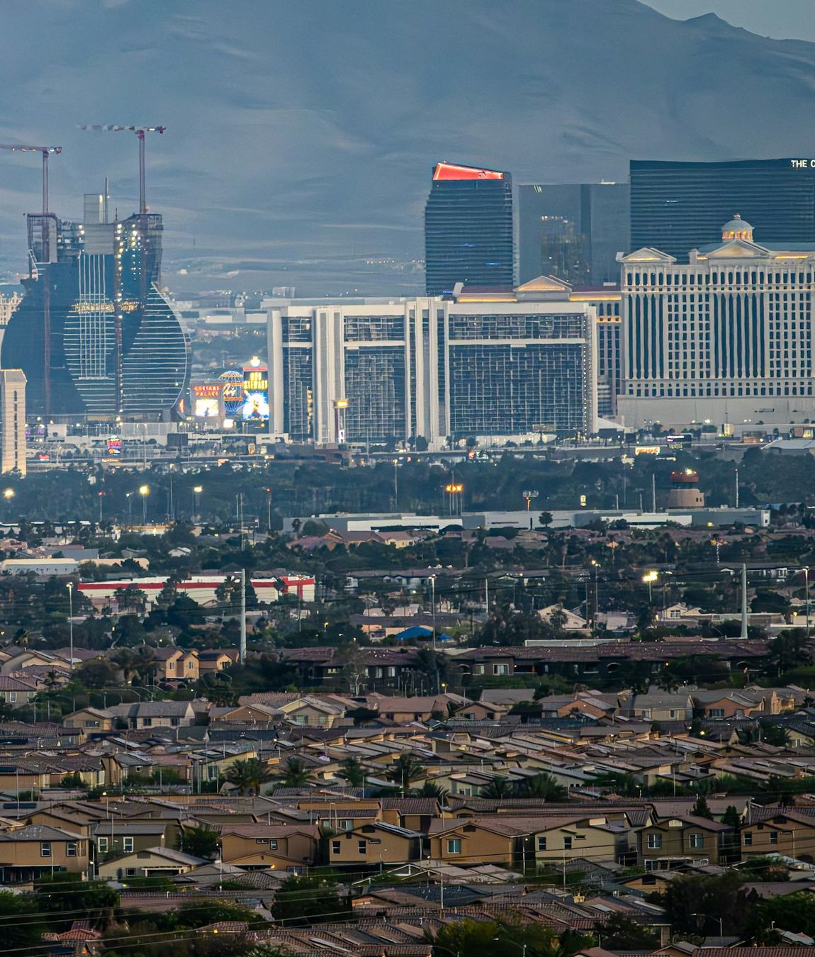 Las Vegas neighborhoods in the foreground of the Strip at dusk